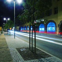 Illuminated light trails on street in city at night