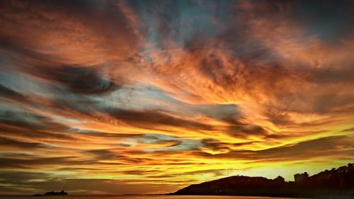 Scenic view of dramatic sky at sunset