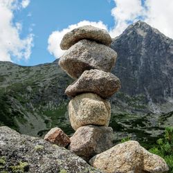 Low angle view of stack of rocks against sky