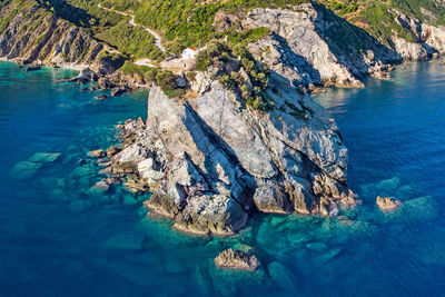 High angle view of rocks on sea shore