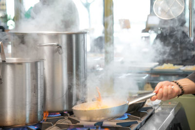 Midsection of man preparing food in kitchen