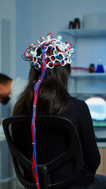 Rear view of woman having eeg treatment