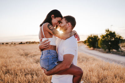 Couple kissing on field