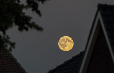 Low angle view of moon against sky at night