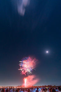 Low angle view of firework display at night