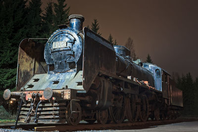 Abandoned train on railroad track at dusk