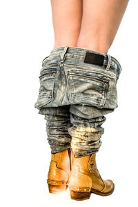 Low section of woman standing against white background