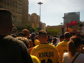 Rear view of people on street in city