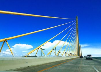 Low angle view of bridge against blue sky