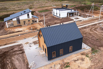 High angle view of houses on field by buildings