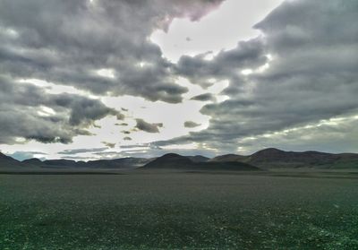 Scenic view of landscape against cloudy sky