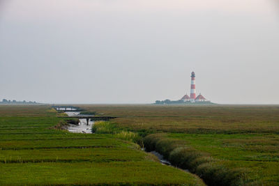 View of lighthouse on field against sky