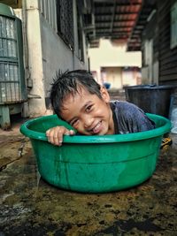 Portrait of smiling boy in bucket