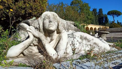 Statue in park against sky