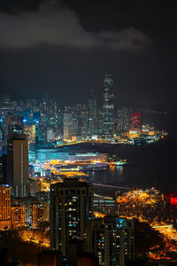 Illuminated cityscape against sky at night