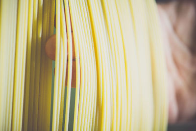 Close-up of hand checking spaghetti drying in factory