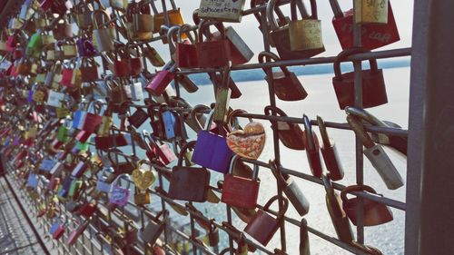 Padlocks hanging on railing