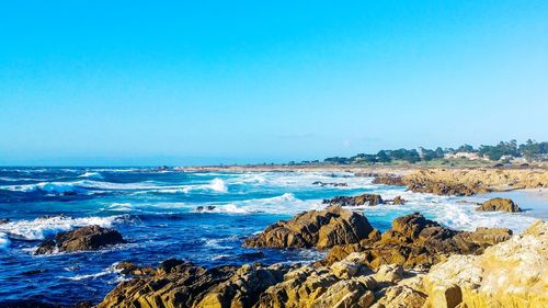 Scenic view of sea against clear blue sky