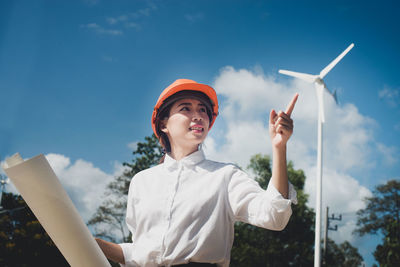 Engineer holding blueprint while working at industry