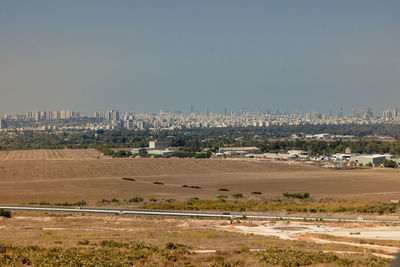 Aerial view of city buildings against clear sky