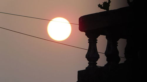 Low angle view of silhouette statue against sky during sunset