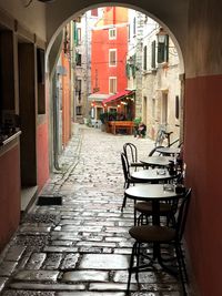 Empty alley amidst buildings in city