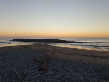 Scenic view of sea against clear sky during sunset