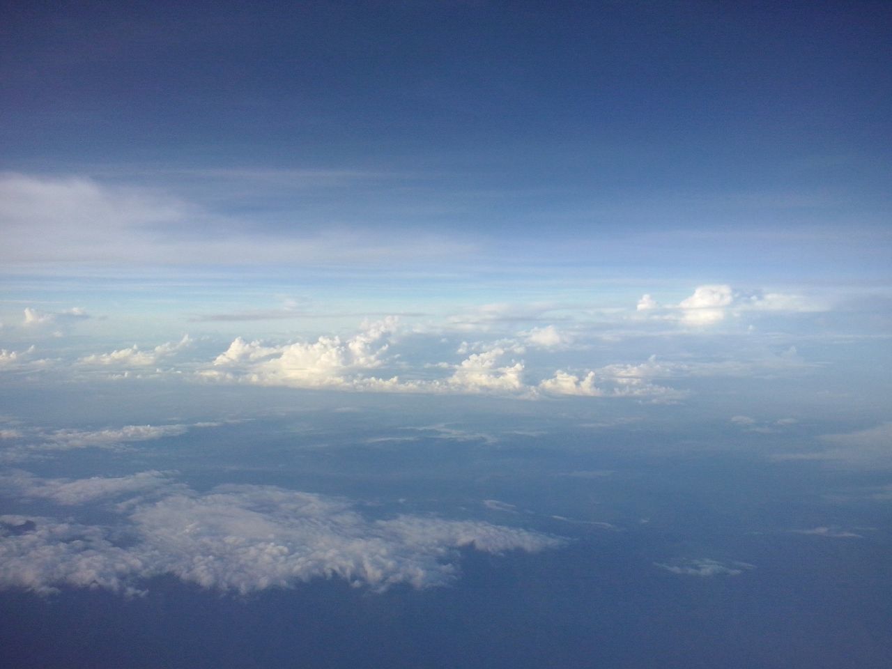 scenics, beauty in nature, sky, tranquil scene, blue, tranquility, aerial view, nature, cloud - sky, cloudscape, cloud, idyllic, landscape, sky only, majestic, white color, no people, day, outdoors, copy space