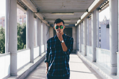 Young man wearing sunglasses standing outdoors