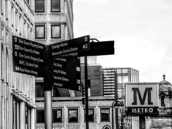 Low angle view of road sign against sky