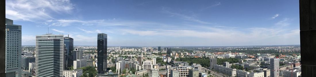 Panoramic view of modern buildings in city against sky