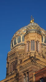 Low angle view of building against clear blue sky