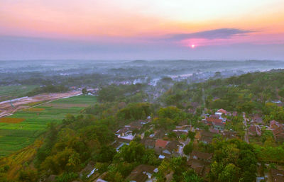 High angle view of houses and trees against sky