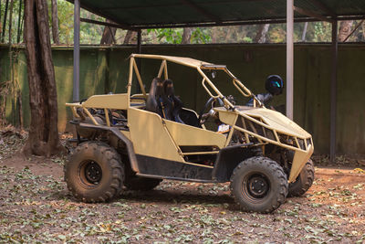 A yellow buggy is parked.
