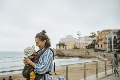 Mother with baby relaxing on beach