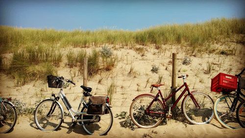 Bicycles on landscape against sky