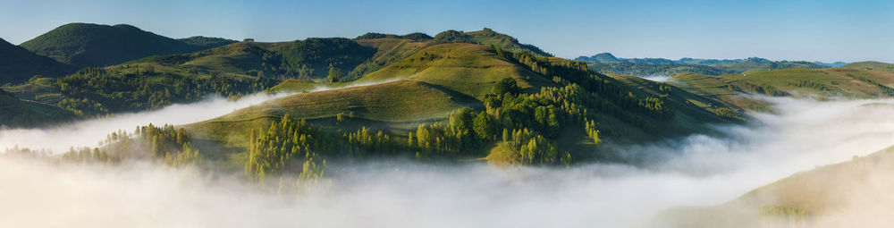 Scenic view of mountains covered with fog