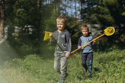 Little boys with butterfly nets in countryside. image with selective focus