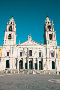 Low angle view of historic building against clear blue sky