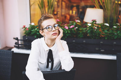 Portrait of young woman using mobile phone