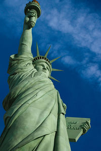 Low angle view of statue against blue sky