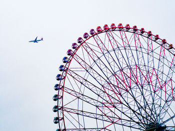 Low angle view of ferris wheel against sky