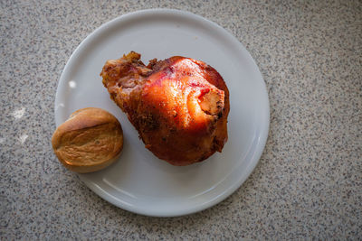 High angle view of fried chicken with bread in plate on marble