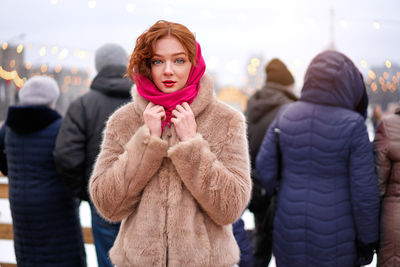 Portrait of woman standing in snow