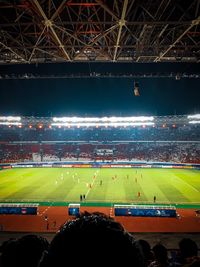 Group of people on soccer field at night
