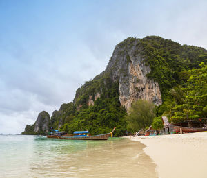 Scenic view of sea and mountains against sky