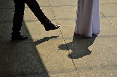 Groom is leaving dark side in his way to the marriage, stepping out the shadow