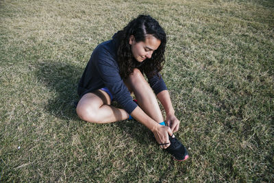 Young woman tying her sneakers