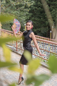 Portrait of young woman exercising in park