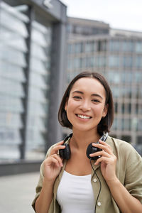 Businesswoman talking on mobile phone in city